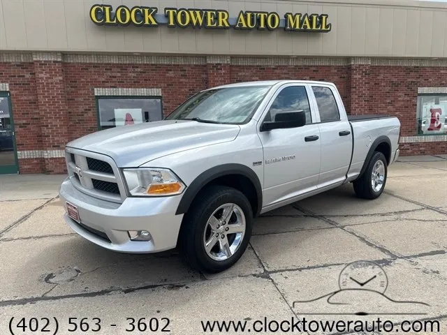 2012 RAM 1500 1500 in front of used car dealership